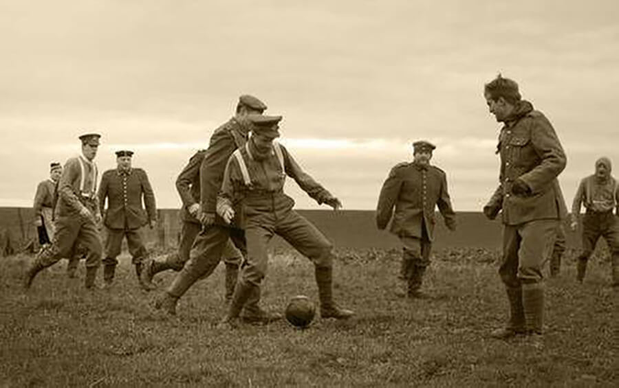 Soldiers in uniform playing soccer